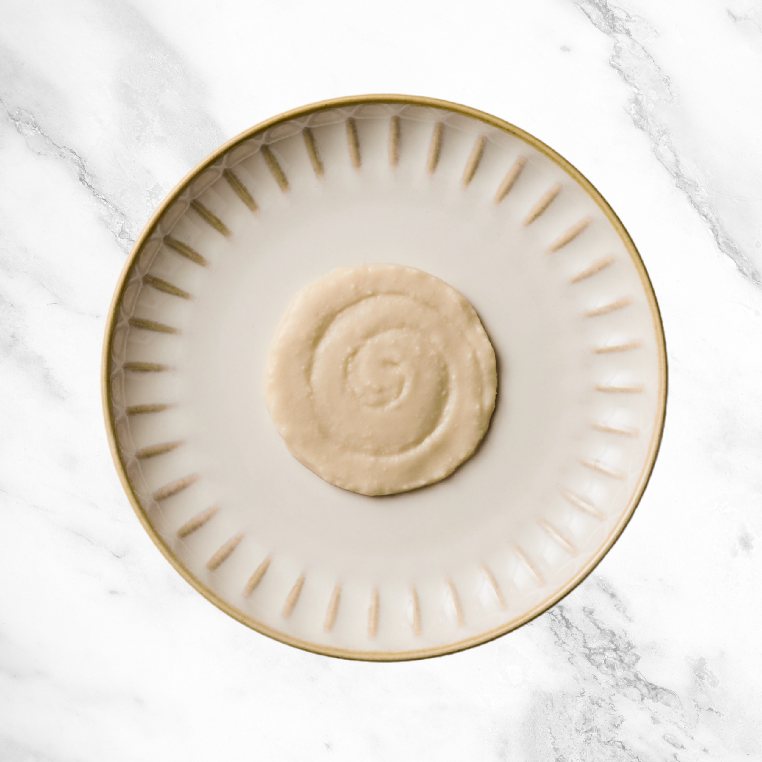 Reveal lickable cat treat puree on a plate