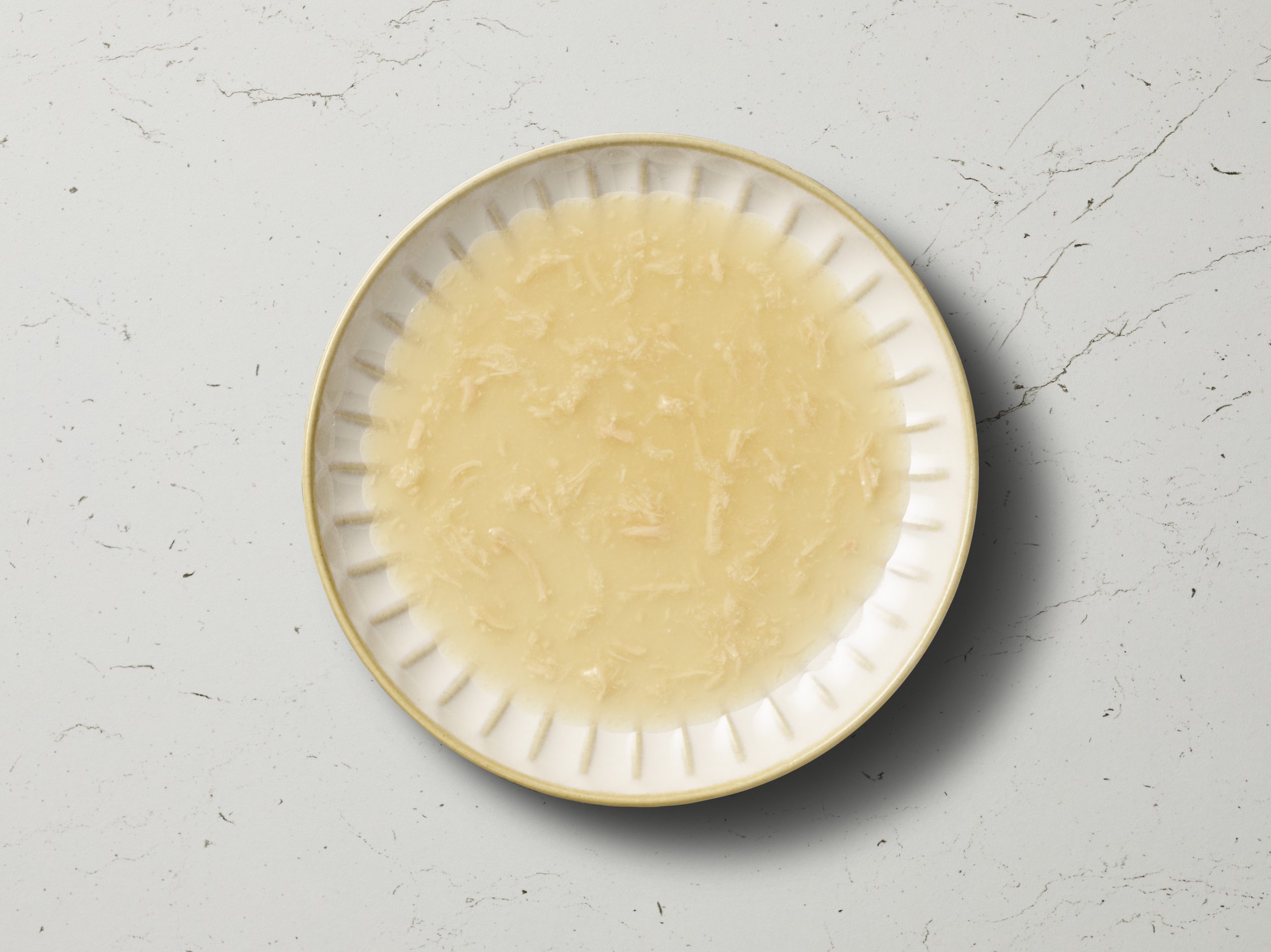 overhead image of chicken bone broth in bowl